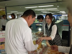 元気いっぱい笑顔の新入社員が来場会員に「わらび餅」を提供