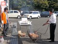 会員サービスで地鶏の炭火焼きを手伝う平山流通委員長