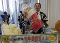 賞品の超巨大クリスマスブーツを持つ青年部の加藤久義氏